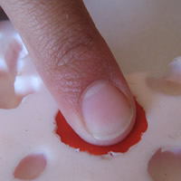 press polymer clay into silicone rubber mould