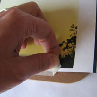 peel masking tape from design and board