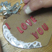 glue mirror border on mosaic heart board