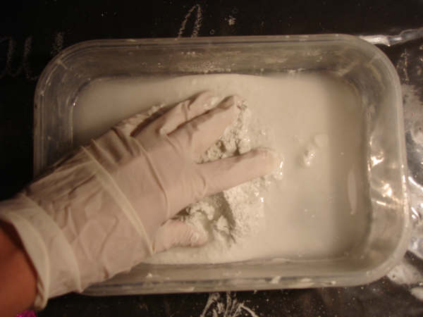 mixing grout powder into paste