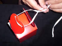 tie raffia or ribbon onto heart shaped valentines day gift box