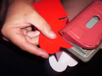 punch holes into valentines heart box