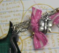 wrap charms and ribbon onto scrapbook project