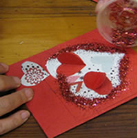 glue glitter onto valentines day heart card