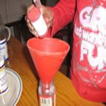 Pour the red food colourin into the vinager
