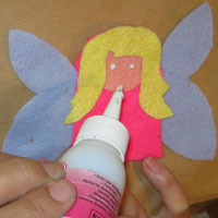 make two dabs of glue to stick the fairy eyes in place