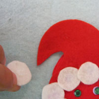 glue white pompom onto hat
