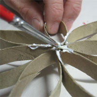 dab construction glue on recycled cardboard petal
