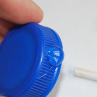 glue skewer onto bottle cap