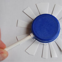 glue plastic flower shape onto plastic bottlecap