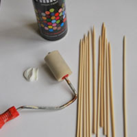 paint skewer sticks with acrylic paint and roller
