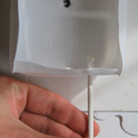 push skewer through plastic milk bottle base