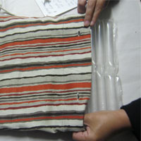 push recycled bubblewrap into shopping bag 