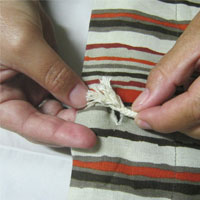 thread cord through the recycled shopping bag